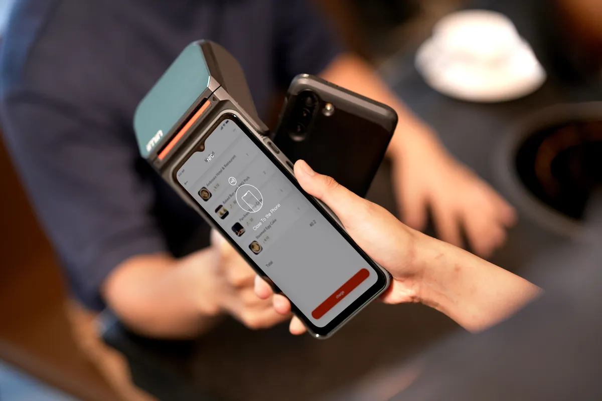 スマートフォンを決済端末へかざす様子のイメージ